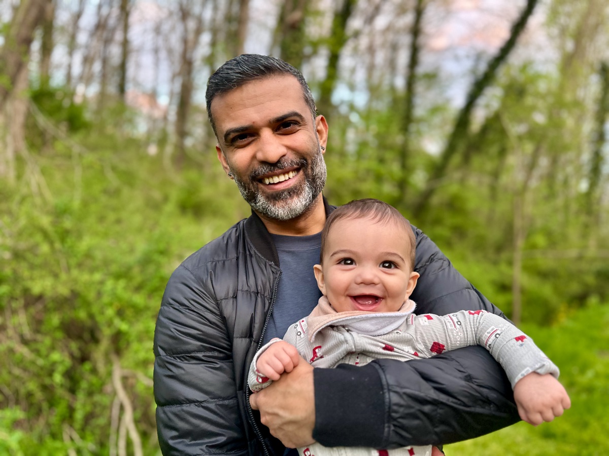 Ro laughing with his son Rowan in the woods